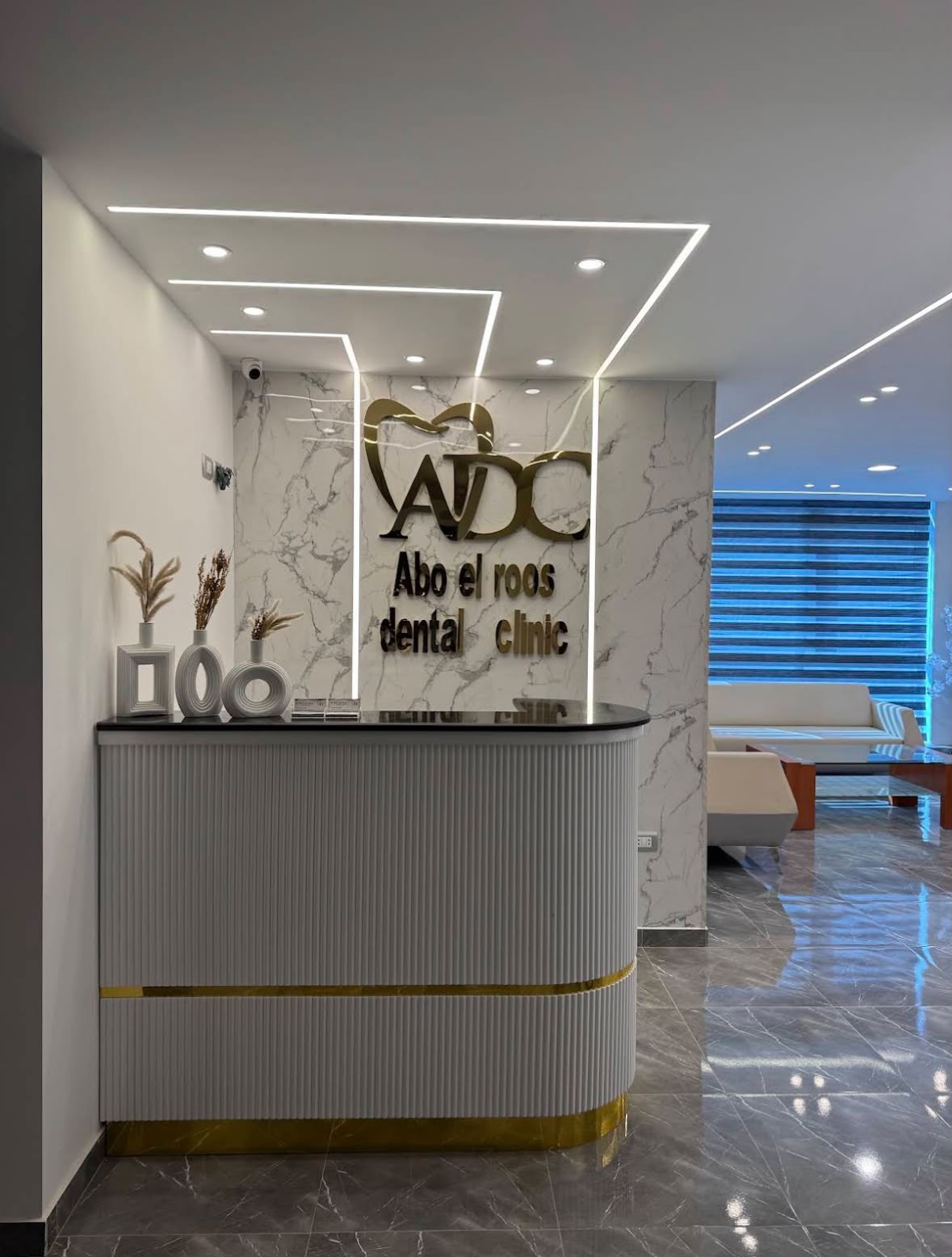 Reception desk with the Abuelroos Dental Clinic signage
